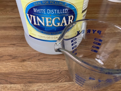 You can flush an AC drain line with distilled white vinegar.